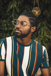 a man wearing glasses and a striped t - shirt